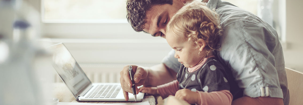 dad showing daughter laptop