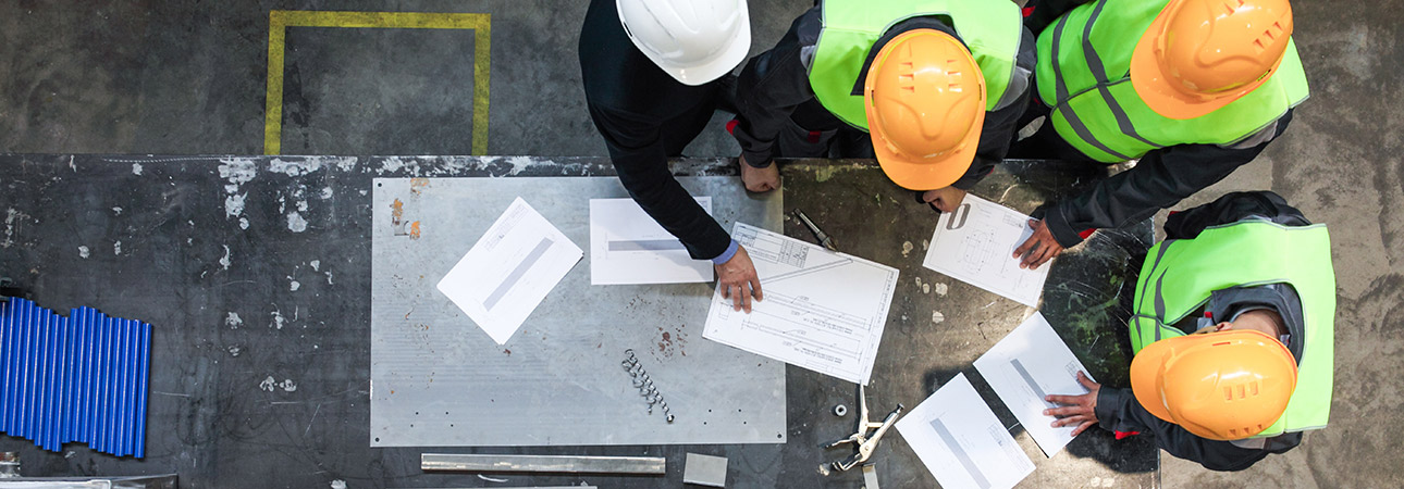 construction workers looking at plans