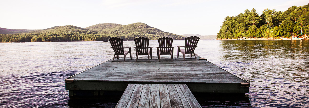 chairs on pier overlooking lake